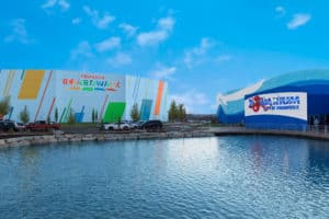 Things to to with kids in Branson Boardwalk Pond with Boardwalk sign and Aquarium in the Background