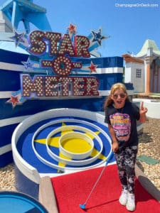 Things to do with Kids in Branson Mini Golf Girl playing mini golf in Branson